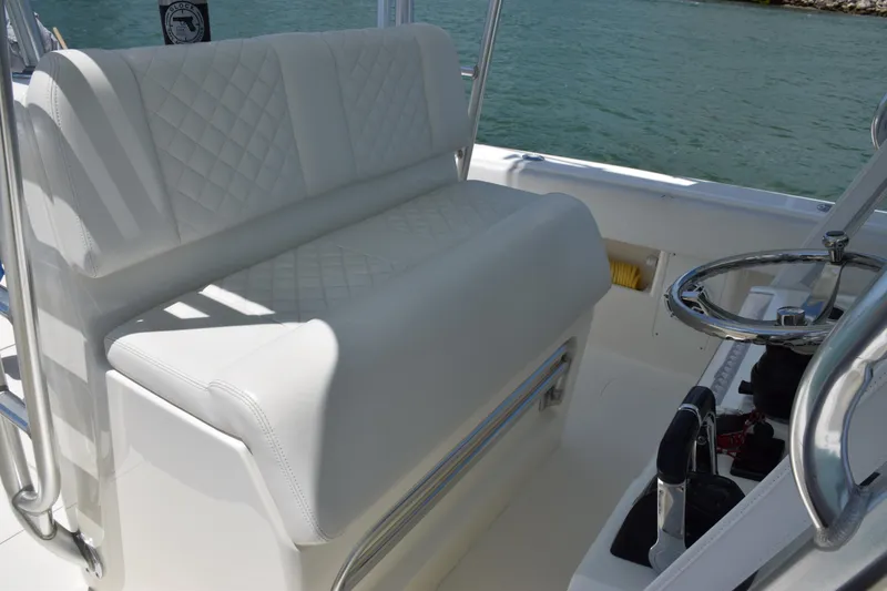 Slide: The Image of 2015 SeaVee 370z boat with white cushioned seating and steering wheel. - 28