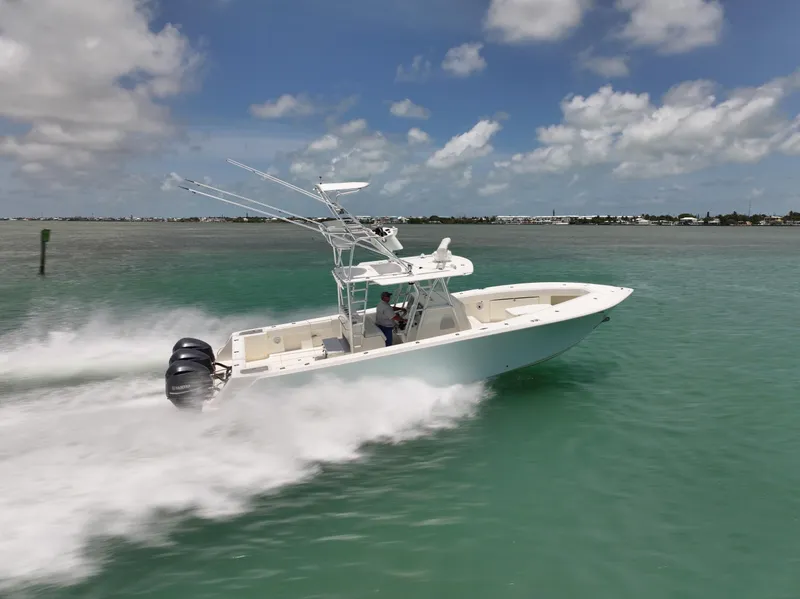 Slide: The Image of 2015 SeaVee 370z boat speeding on turquoise water under a clear sky. - 3