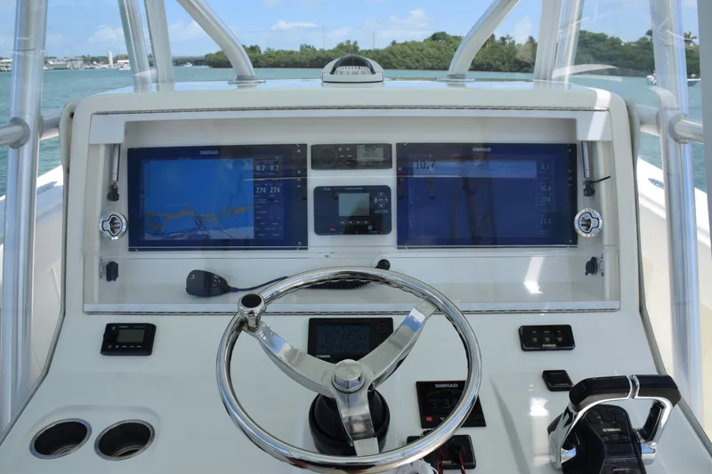 Slide: The Image of 2015 SeaVee 370z boat dashboard with navigation screens and steering wheel. - 31
