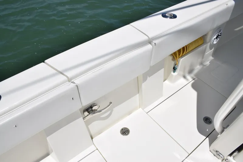 Slide: The Image of 2015 SeaVee 370z boat deck with white seating and storage compartments. - 40