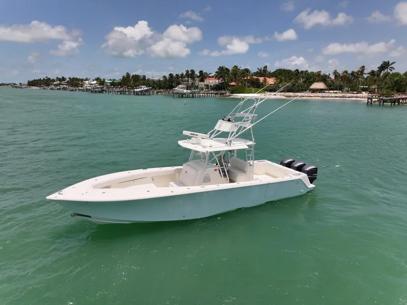 Slide: The Image of 2015 SeaVee 370z boat on turquoise water with coastal background. - 9