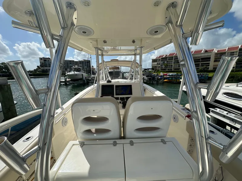 Slide: The Image of 2016 Cobia 296CC boat interior with dual seats and navigation system. - 11