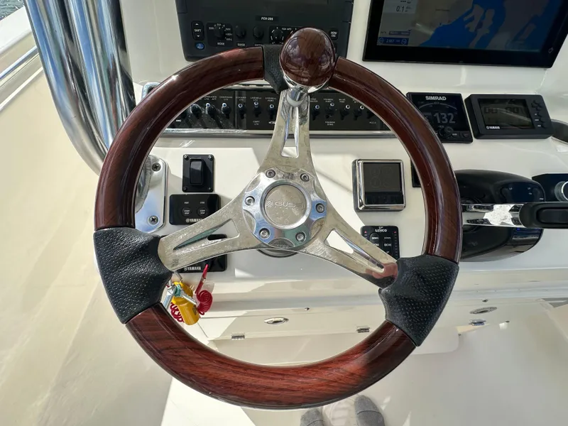 Slide: The Image of 2016 Cobia 296CC boat steering wheel and control panel. - 16