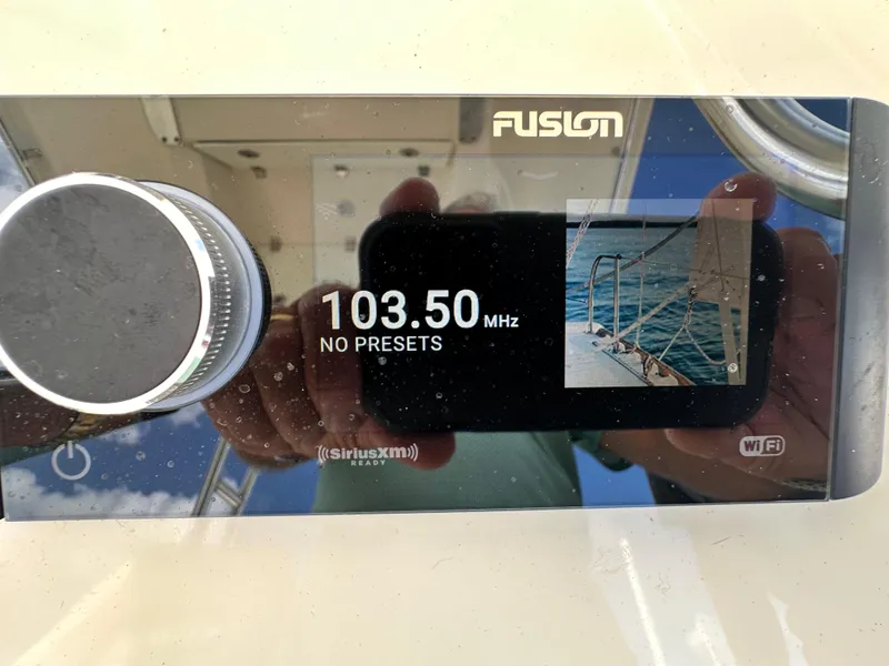 Slide: The Image of Fusion radio display on a 2016 Cobia 296CC boat showing 103.50 MHz frequency. - 18