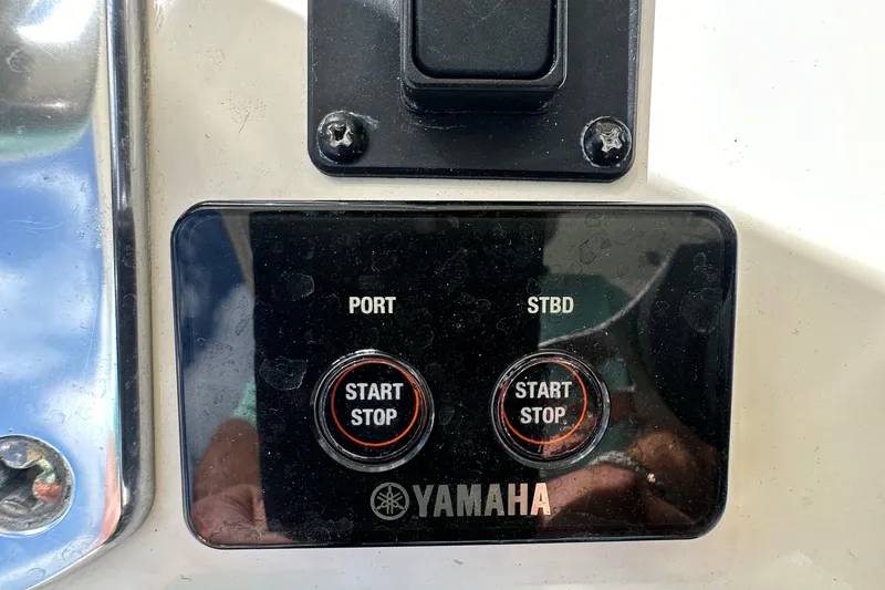 Slide: The Image of Yamaha start/stop buttons on a 2016 Cobia 296CC boat. - 23