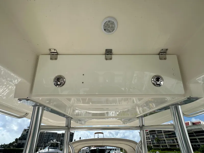 Slide: The Image of 2016 Cobia 296CC boat overhead storage compartment. - 24