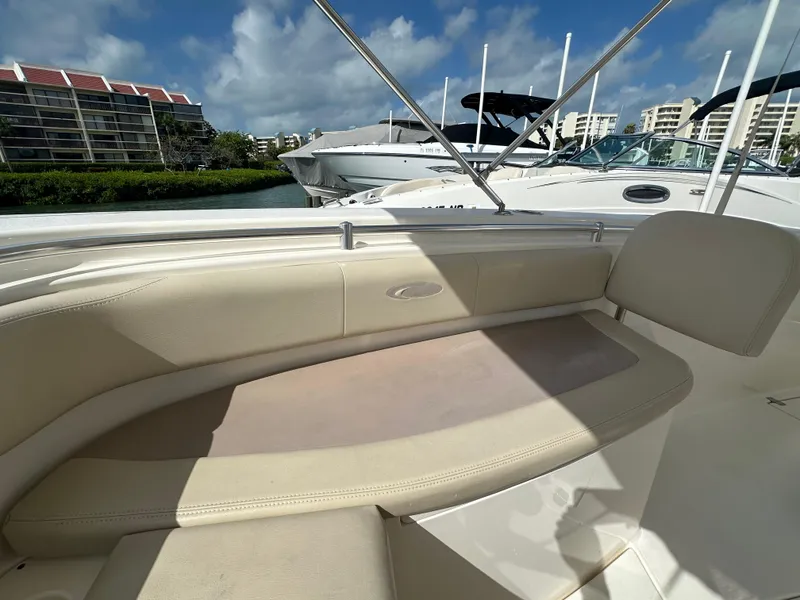 Slide: The Image of 2016 Cobia 296CC boat interior seating with waterfront view. - 27