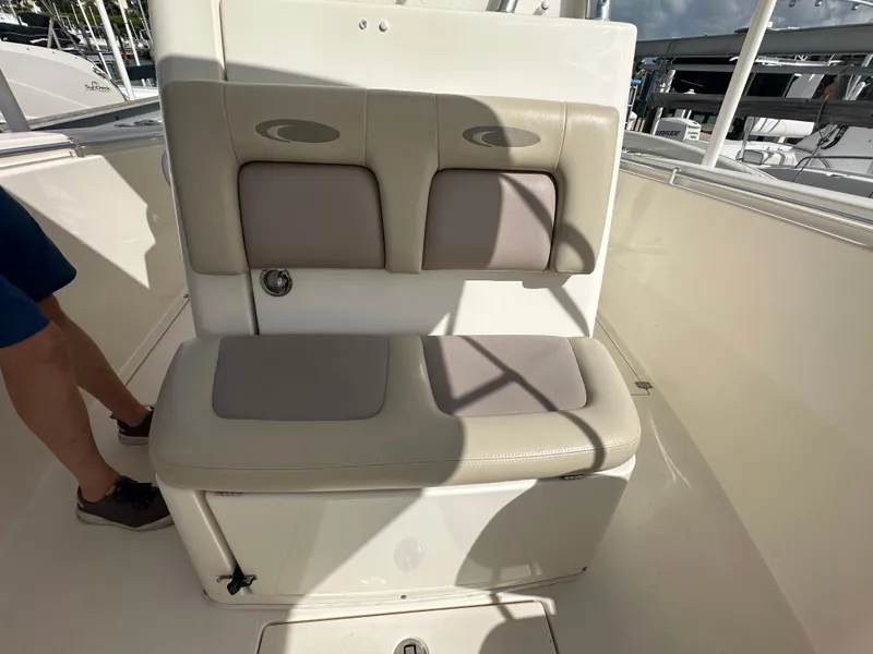 Slide: The Image of 2016 Cobia 296CC boat seating area with cushioned bench and backrest. - 31