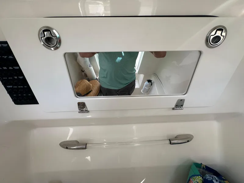 Slide: The Image of Cobia 296CC 2016 model boat interior with storage compartment and mirror. - 33