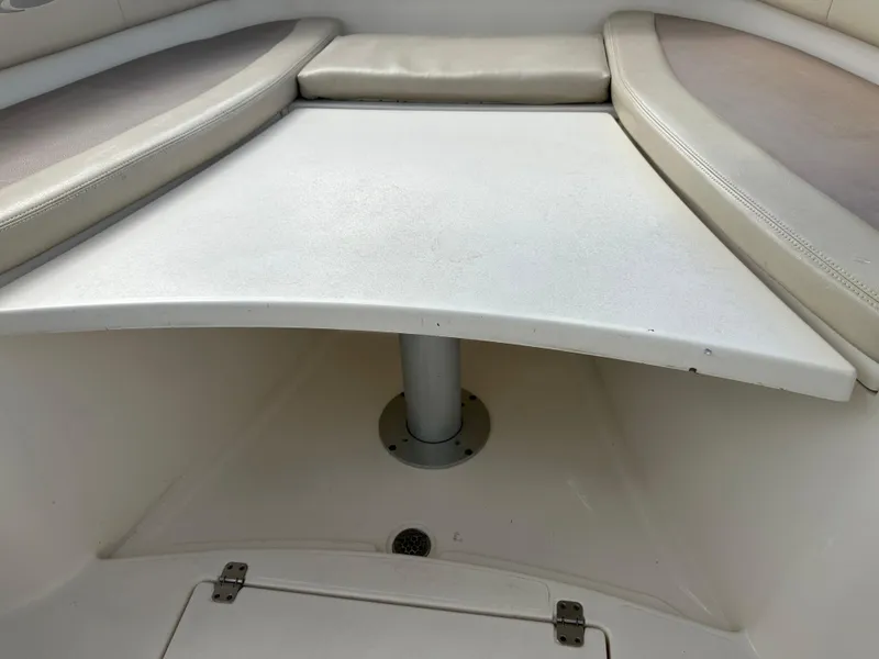 Slide: The Image of 2016 Cobia 296CC boat seating area with table. - 39