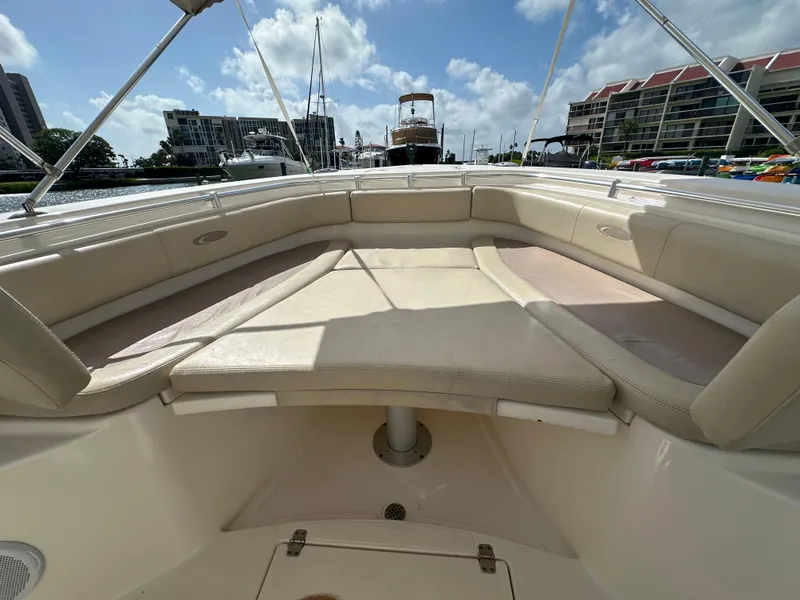 Slide: The Image of 2016 Cobia 296CC boat with spacious seating area and scenic marina backdrop. - 40