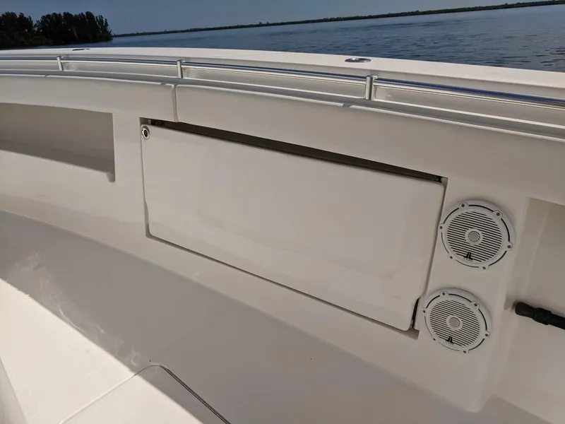 Slide: The Image of 2014 Invincible 42 Open Fisherman boat interior with storage compartment and speakers. - 12