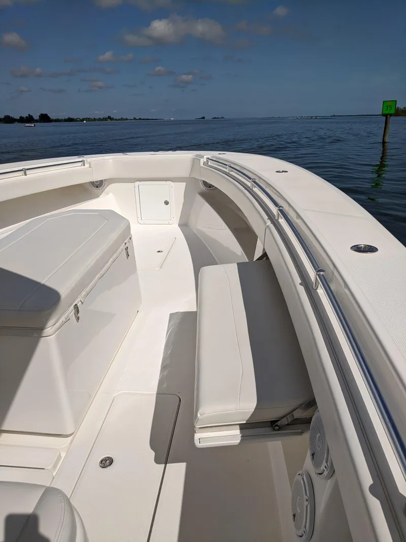 Slide: The Image of 2014 Invincible 42 Open Fisherman boat interior with seating and storage. - 14