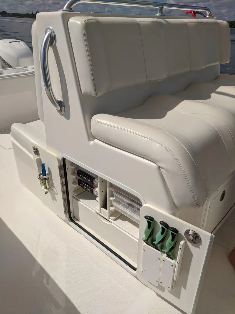 Slide: The Image of 2014 Invincible 42 Open Fisherman boat with white cushioned seating and storage compartments. - 15