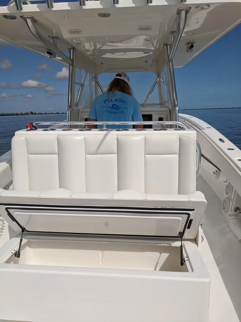 Slide: The Image of 2014 Invincible 42 Open Fisherman boat with white seating and a person at the helm. - 17