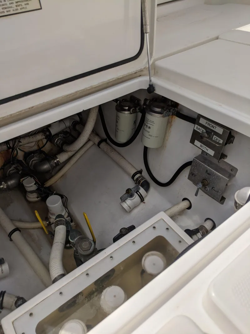 Slide: The Image of 2014 Invincible 42 Open Fisherman engine compartment with fuel filters and plumbing. - 19