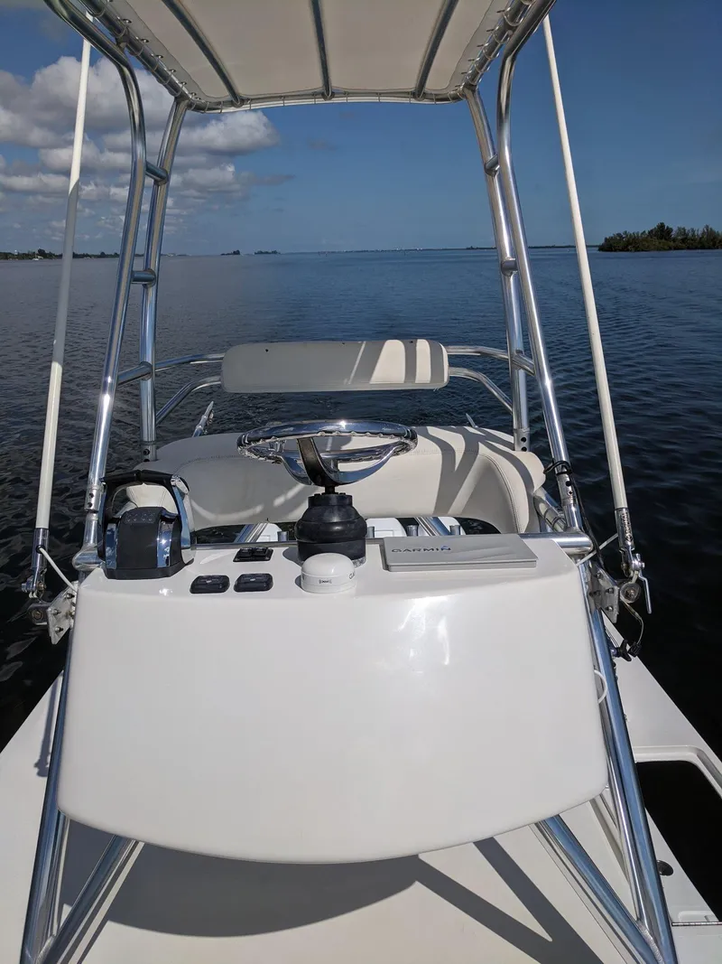 Slide: The Image of 2014 Invincible 42 Open Fisherman boat console on calm waters. - 20