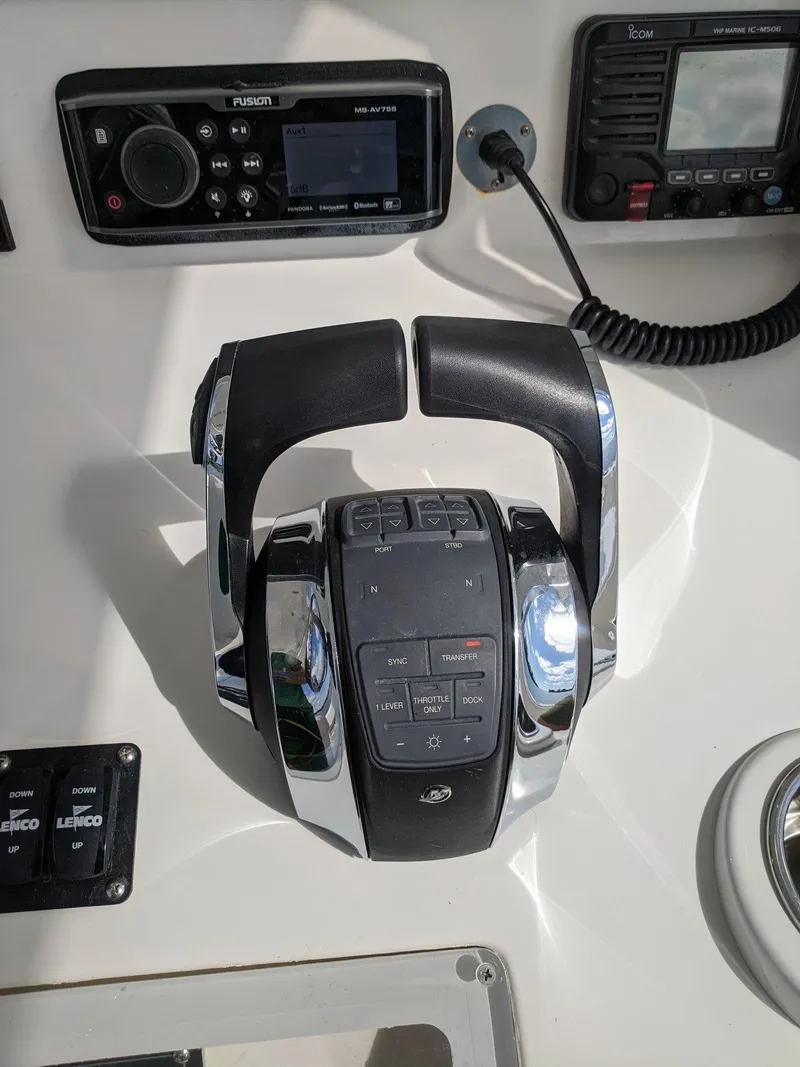 Slide: The Image of 2014 Invincible 42 Open Fisherman control panel with throttle and navigation equipment. - 4