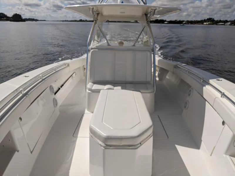 Slide: The Image of 2014 Invincible 42 Open Fisherman boat cruising on a calm lake. - 6