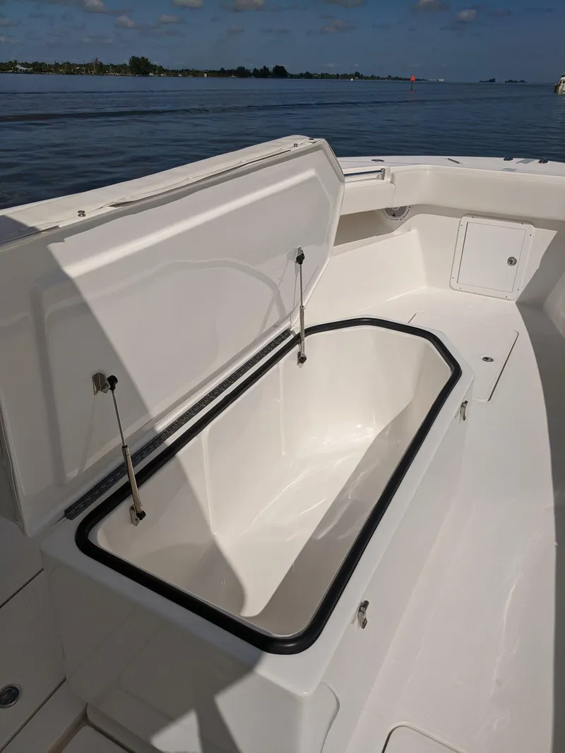 Slide: The Image of 2014 Invincible 42 Open Fisherman boat with open storage compartment. - 9