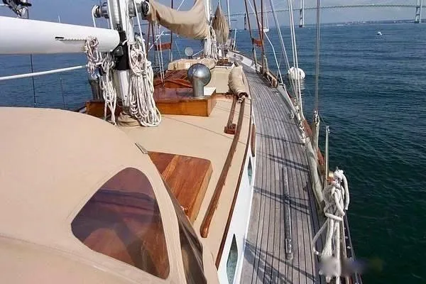 Slide: The Image of 1983 Cherubini Schooner sailing on calm waters, showcasing its deck and rigging. - 10
