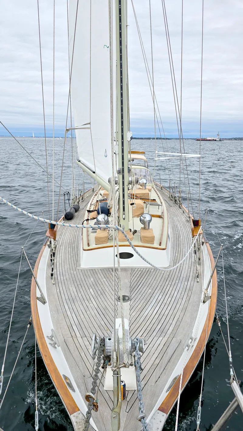 Slide: The Image of 1983 Cherubini Schooner sailing on open water, showcasing elegant wooden deck design. - 12