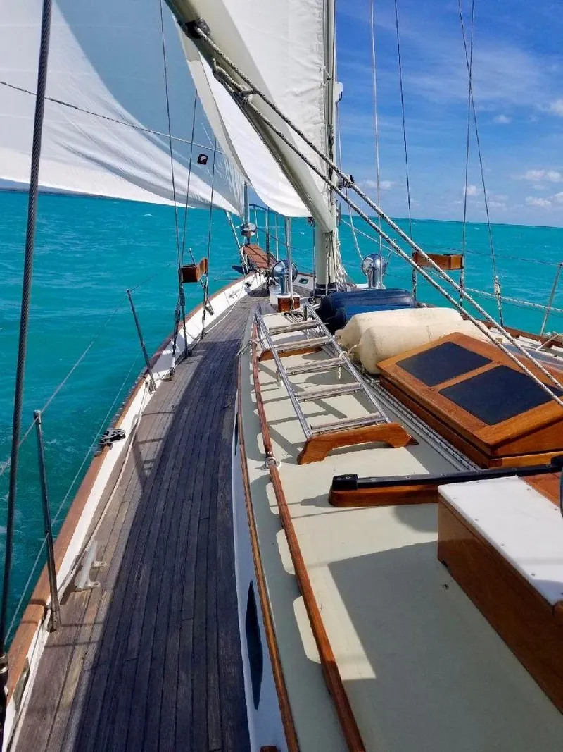 Slide: The Image of 1983 Cherubini Schooner sailing on turquoise waters under a clear blue sky. - 14