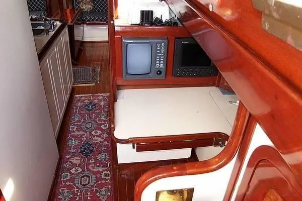 Slide: The Image of 1983 Cherubini Schooner interior with navigation equipment and wooden furnishings. - 16