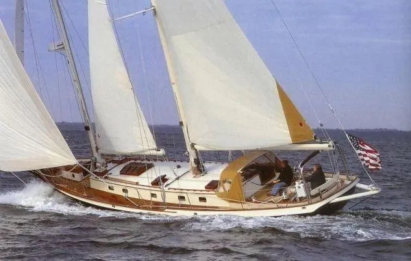 Slide: The Image of 1983 Cherubini Schooner sailing on open water with full sails. - 24