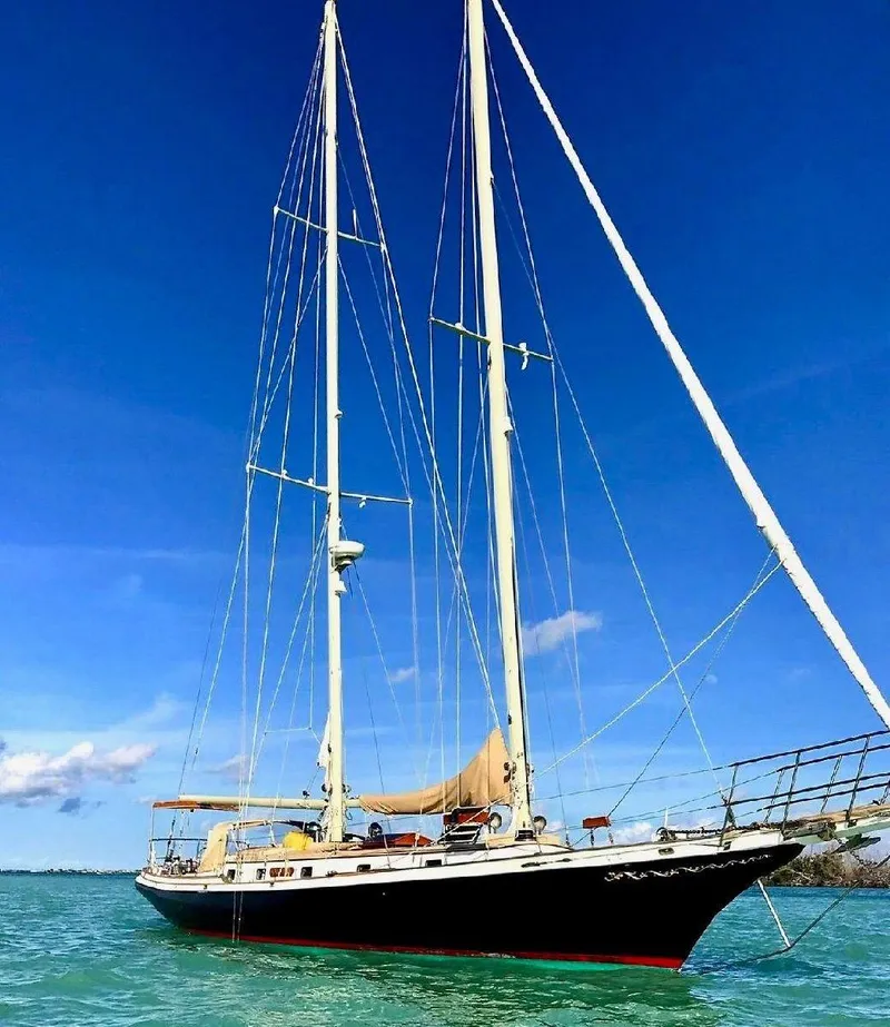 Slide: The Image of 1983 Cherubini Schooner sailing on clear blue waters under a bright sky. - 28