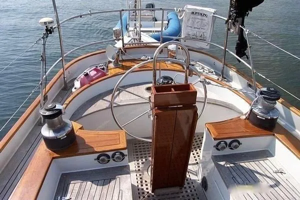 Slide: The Image of 1983 Cherubini Schooner cockpit with wooden accents and steering wheel. - 4