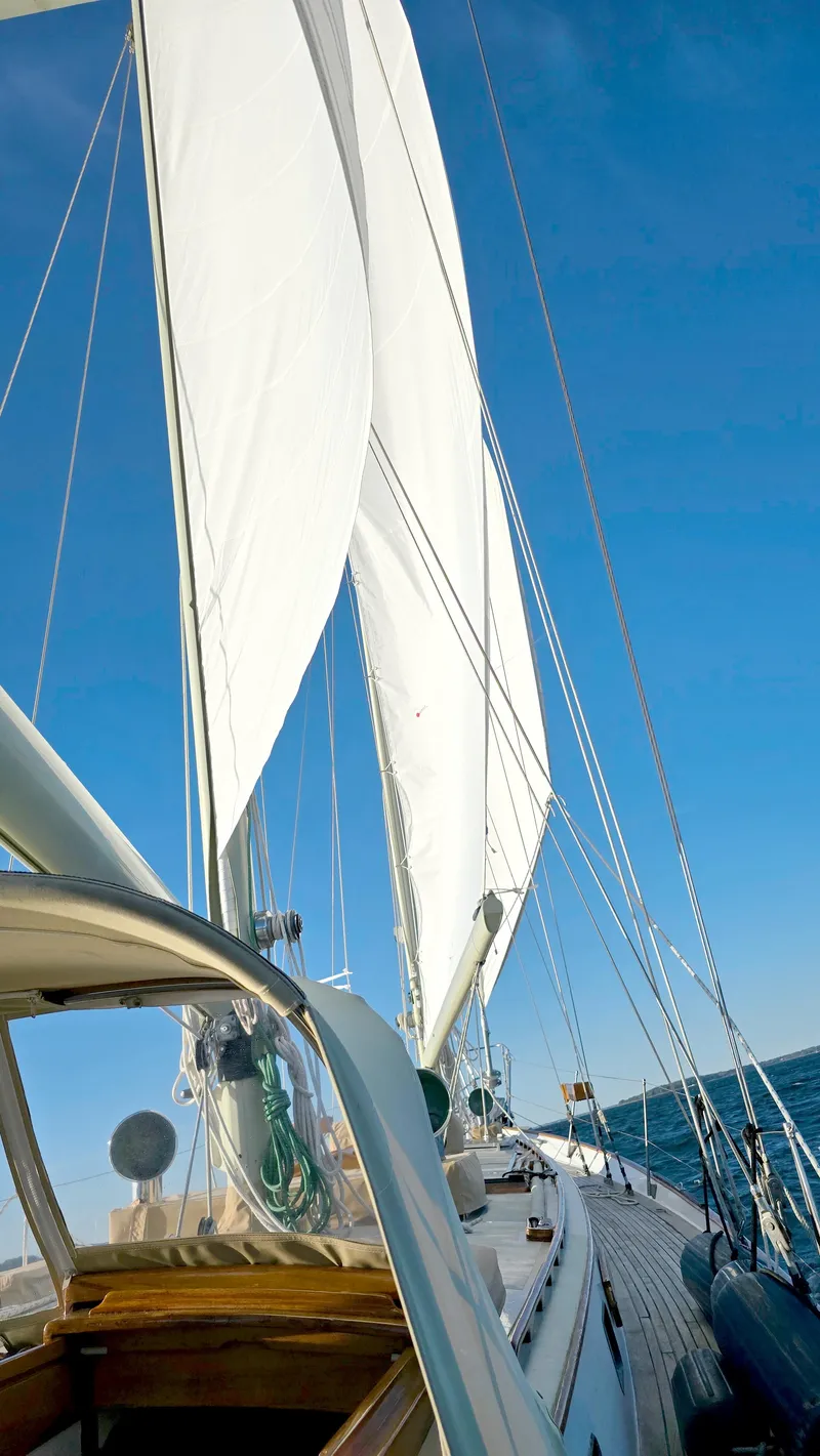 Slide: The Image of Cherubini Schooner 1983 sailing on open sea under clear blue sky. - 5