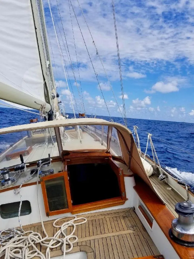 Slide: The Image of 1983 Cherubini Schooner sailing on open ocean under a clear blue sky. - 7