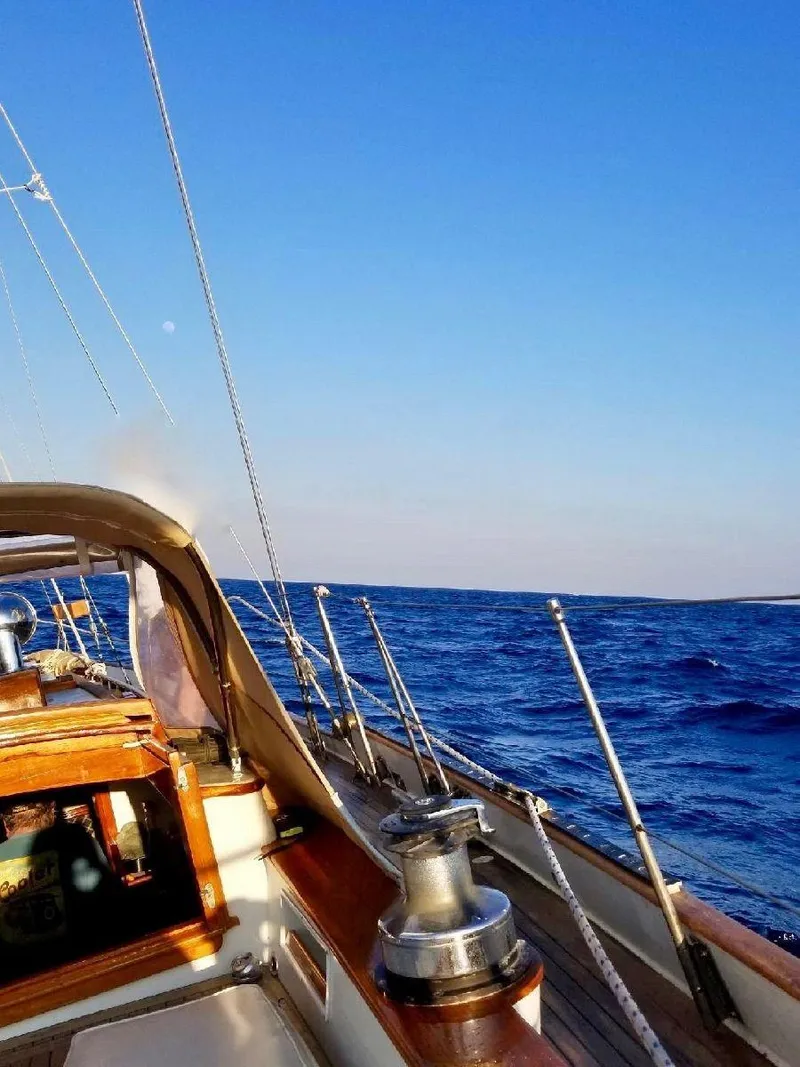 Slide: The Image of 1983 Cherubini Schooner sailing on open blue sea under clear sky. - 9