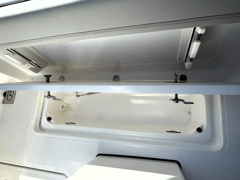 Slide: The Image of 2025 Pursuit S 248 boat with Yeti cooler storage compartment. - 11