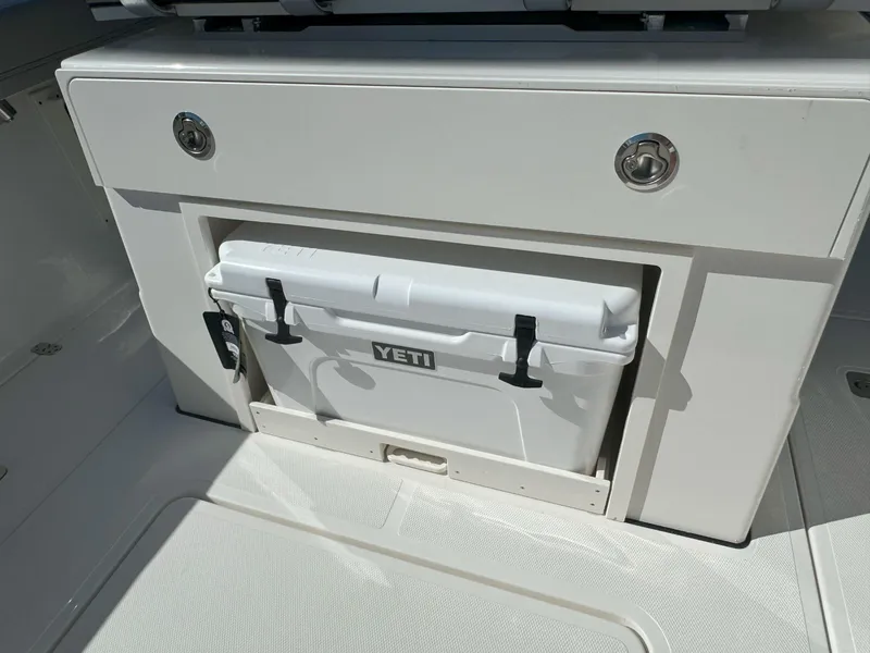 Slide: The Image of 2025 Pursuit S 248 boat storage compartment with open drawers. - 12