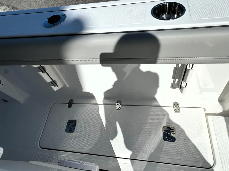 Slide: The Image of 2025 Pursuit S 248 boat with luxurious gray seating at a marina. - 14