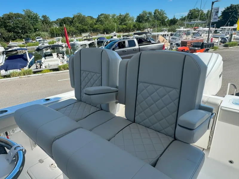 Slide: The Image of 2025 Pursuit S 248 boat dashboard with steering wheel and control panel. - 15