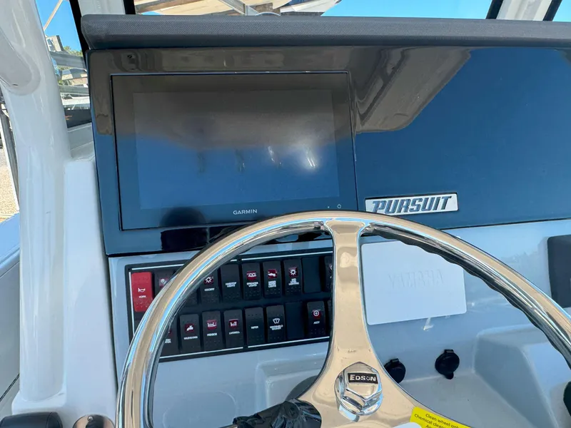 Slide: The Image of 2025 Pursuit S 248 boat console with radio and cup holder. - 17