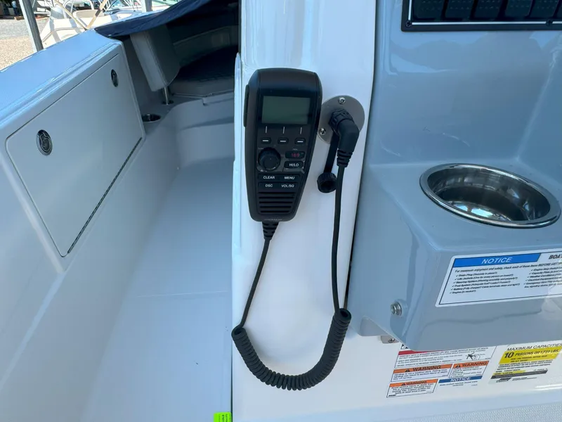 Slide: The Image of 2025 Pursuit S 248 boat interior with storage compartment and speaker. - 18