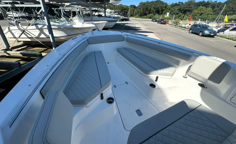 Slide: The Image of 2025 Pursuit S 248 boat interior with quilted seating and sleek design. - 21