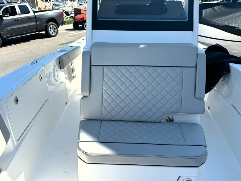 Slide: The Image of 2025 Pursuit S 248 boat speakers and lighting on deck, marina background. - 22