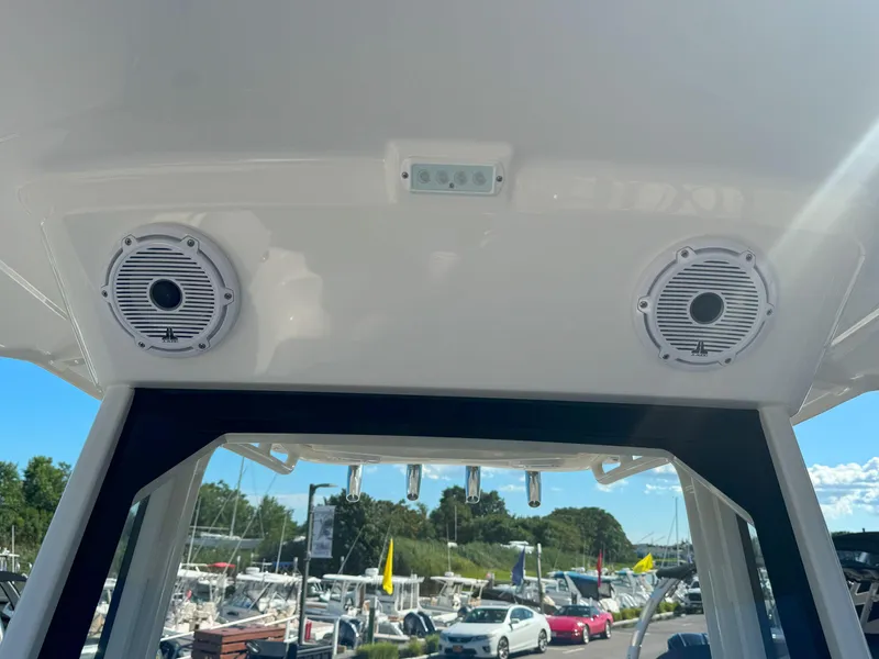 Slide: The Image of 2025 Pursuit S 248 boat interior with open storage compartment and safety equipment. - 23