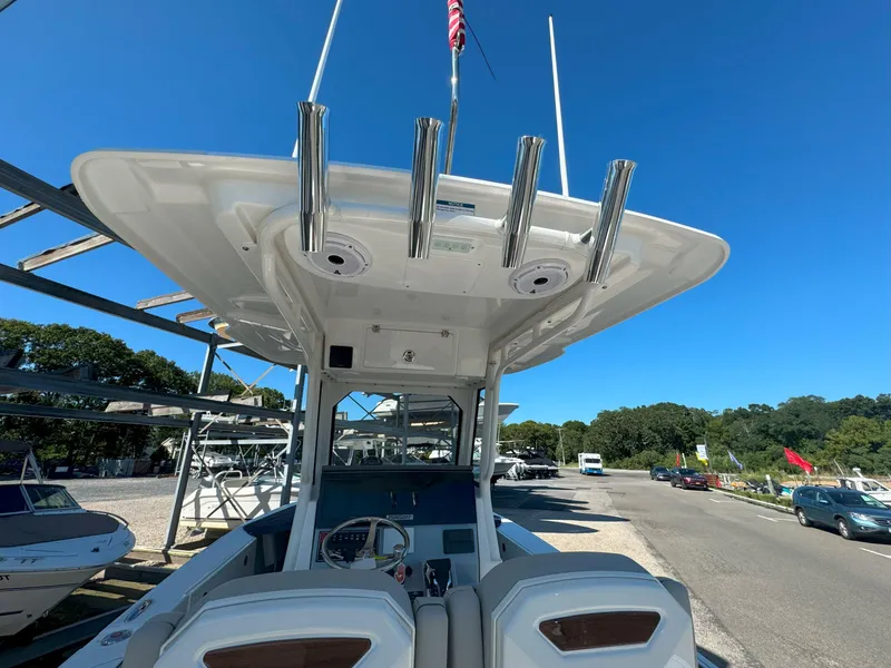 Slide: The Image of 2025 Pursuit S 248 boat seating area with storage compartment and sleek design. - 6