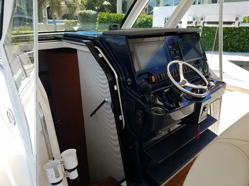 Slide: The Image of 2017 Pursuit S 408 Sport boat helm with modern navigation equipment. - 11