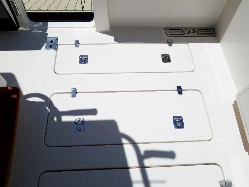 Slide: The Image of 2017 Pursuit S 408 Sport boat deck with storage compartments. - 16