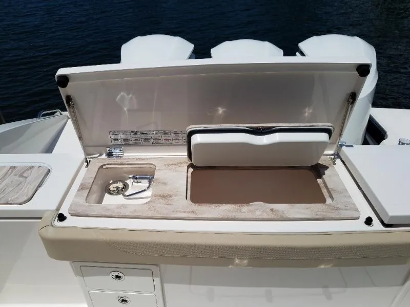 Slide: The Image of 2017 Pursuit S 408 Sport boat with open storage compartment. - 21