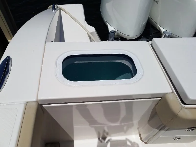 Slide: The Image of 2017 Pursuit S 408 Sport boat livewell and seating area. - 22