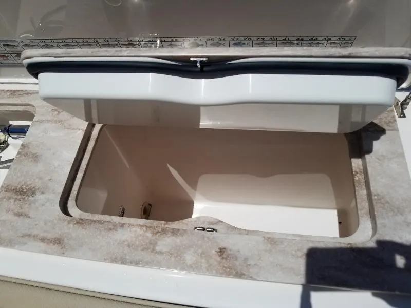 Slide: The Image of Open storage compartment on a 2017 Pursuit S 408 Sport boat. - 23