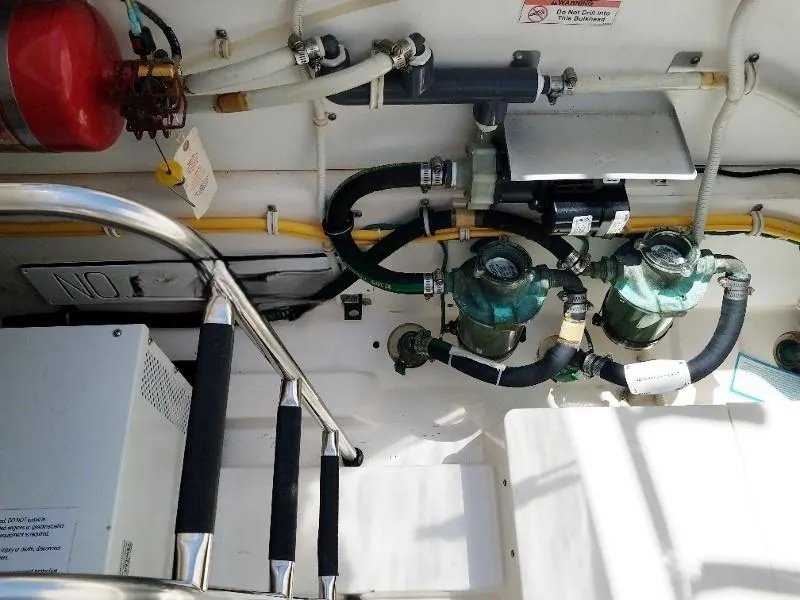 Slide: The Image of 2017 Pursuit S 408 Sport boat engine compartment with hoses and equipment. - 27